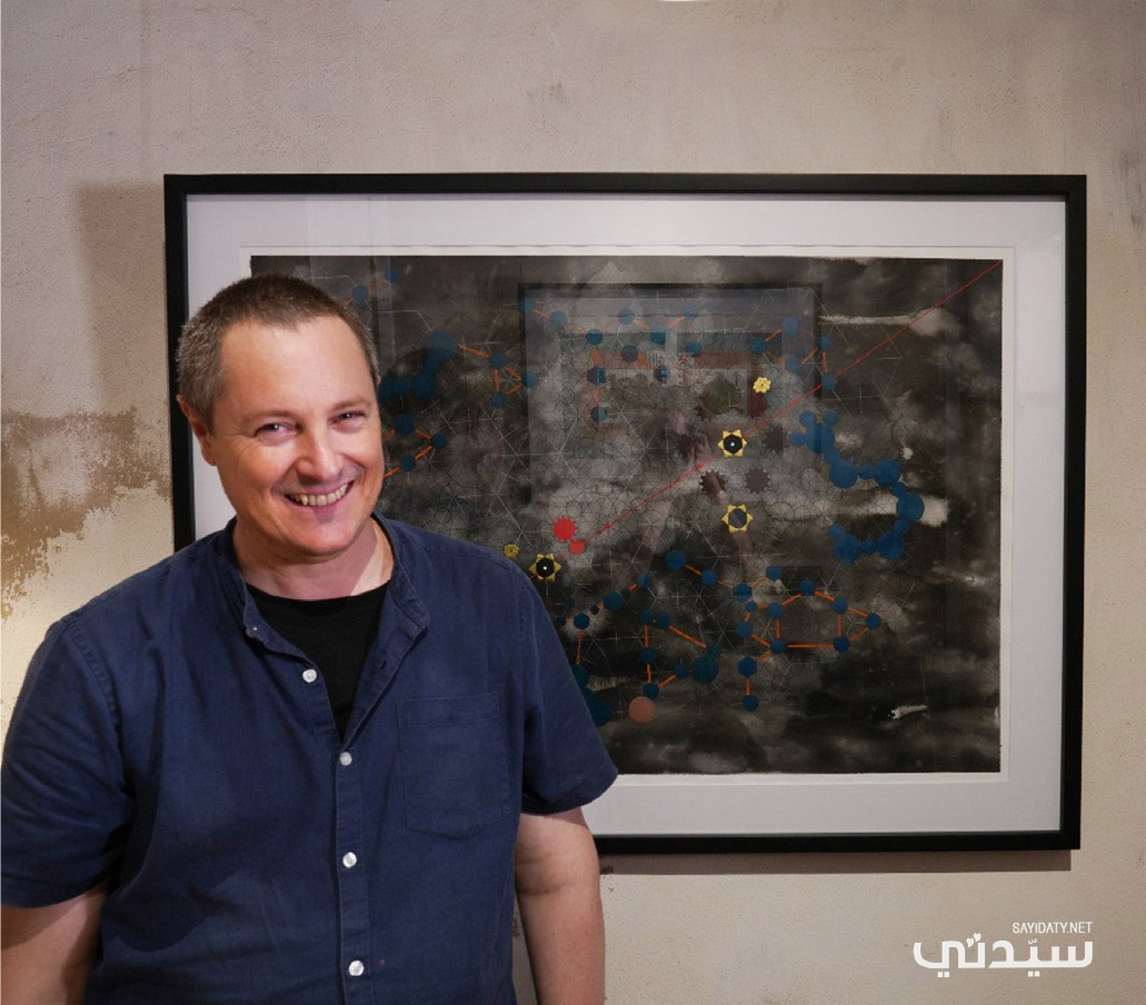 الفنان البريطاني محمود ما نينيغ مع احدى لوحاته