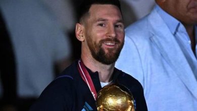 Argentina's captain and forward Lionel Messi (C) holds the FIFA World Cup Trophy upon arrival at Ezeiza International Airport after winning the Qatar 2022 World Cup tournament in Ezeiza, Buenos Aires province, Argentina on December 20, 2022. Luis ROBAYO / AFP
